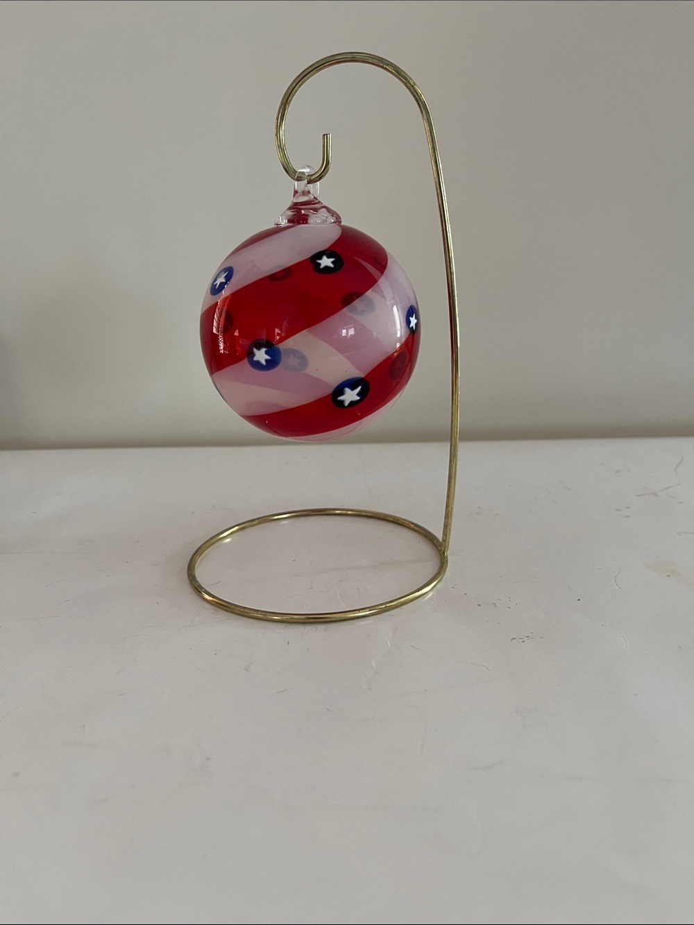 Red and White Hand-Blown Glass Ornament with Blue Star Details
